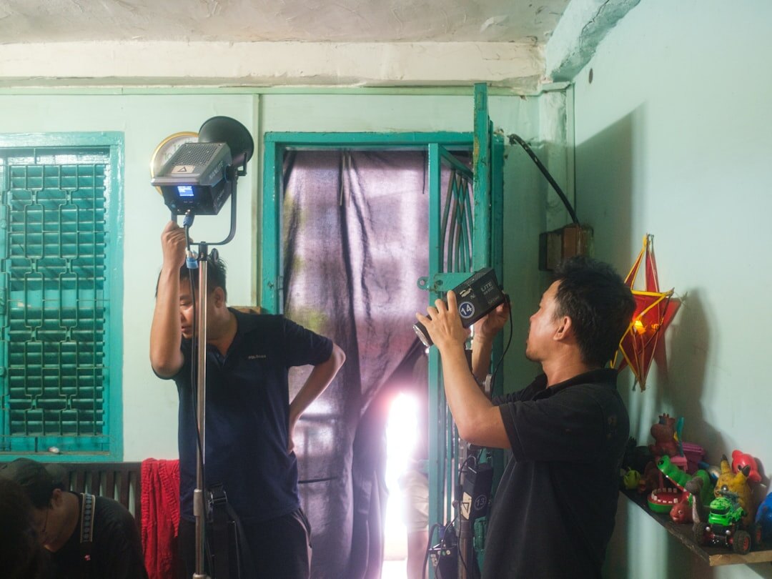 Male camera operator smiling at broadcast studio